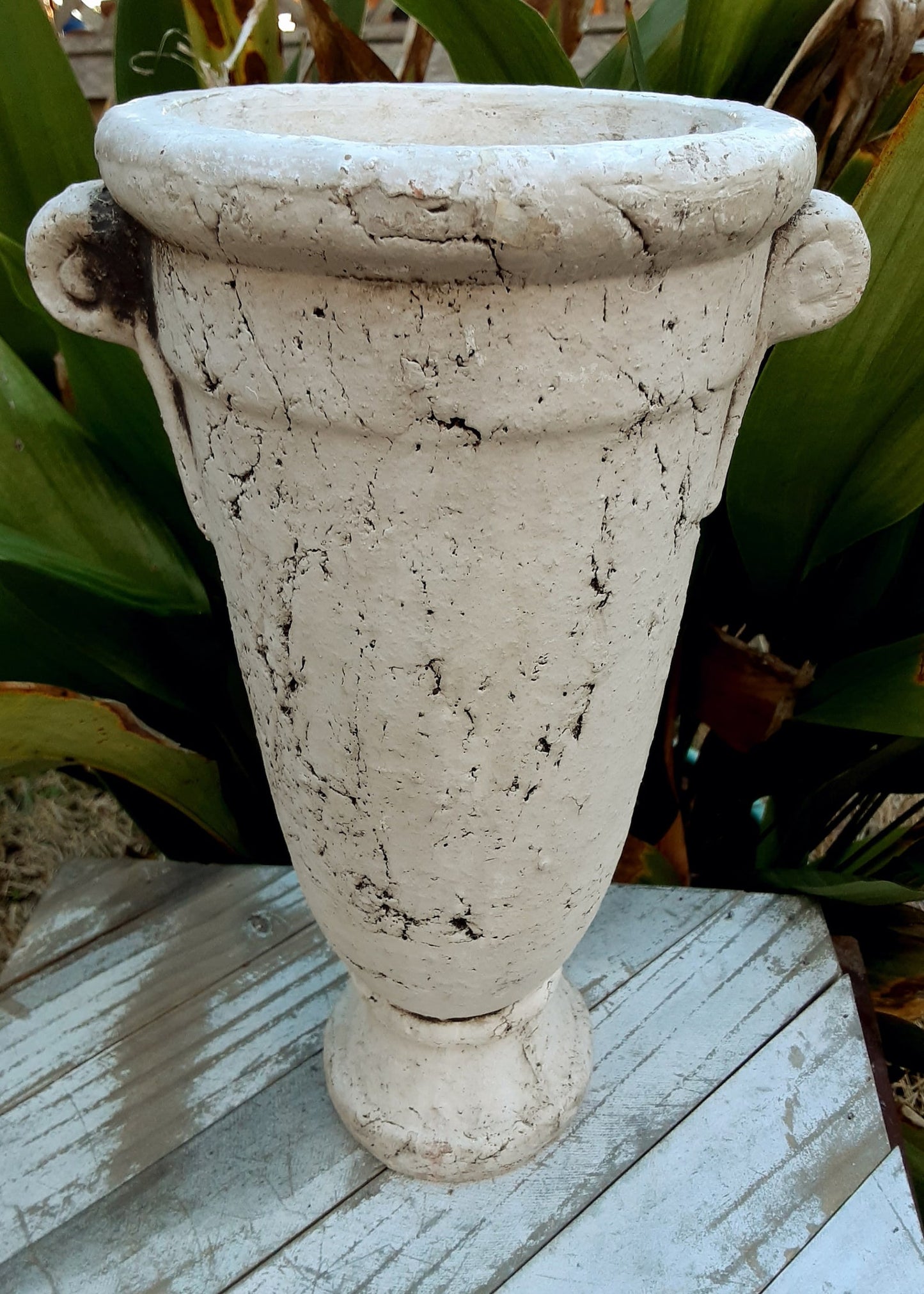 This charming Double Handle White Grecian Style Vase adds old world flair to any space. Made from stone-like resin/terracotta, its flat bottom makes it easy to display. With a weight of three pounds, it's perfect for holding flowers and creating a stunning centerpiece.